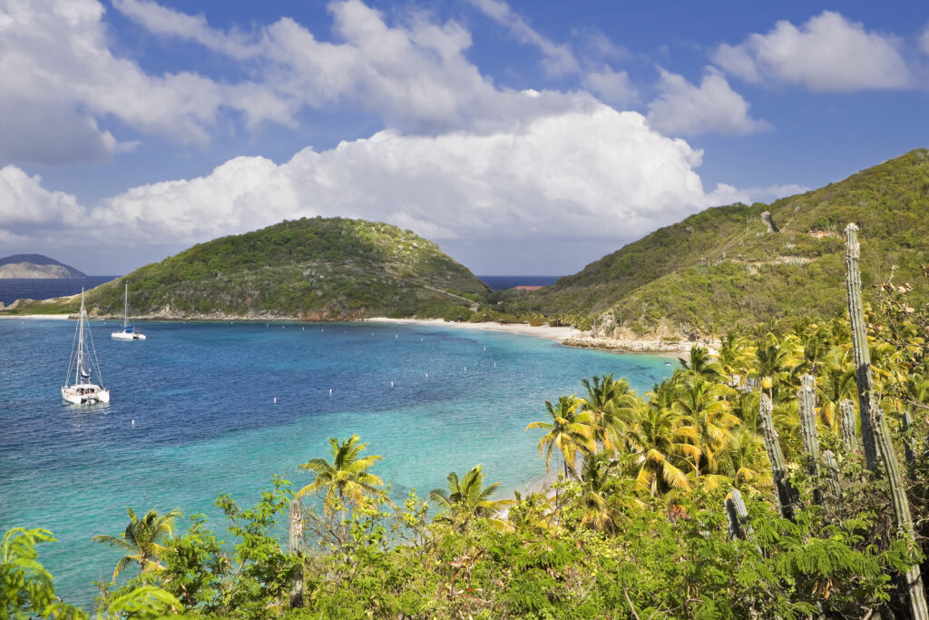 Sailboat anchored in a calm green bay in the Virgin Islands