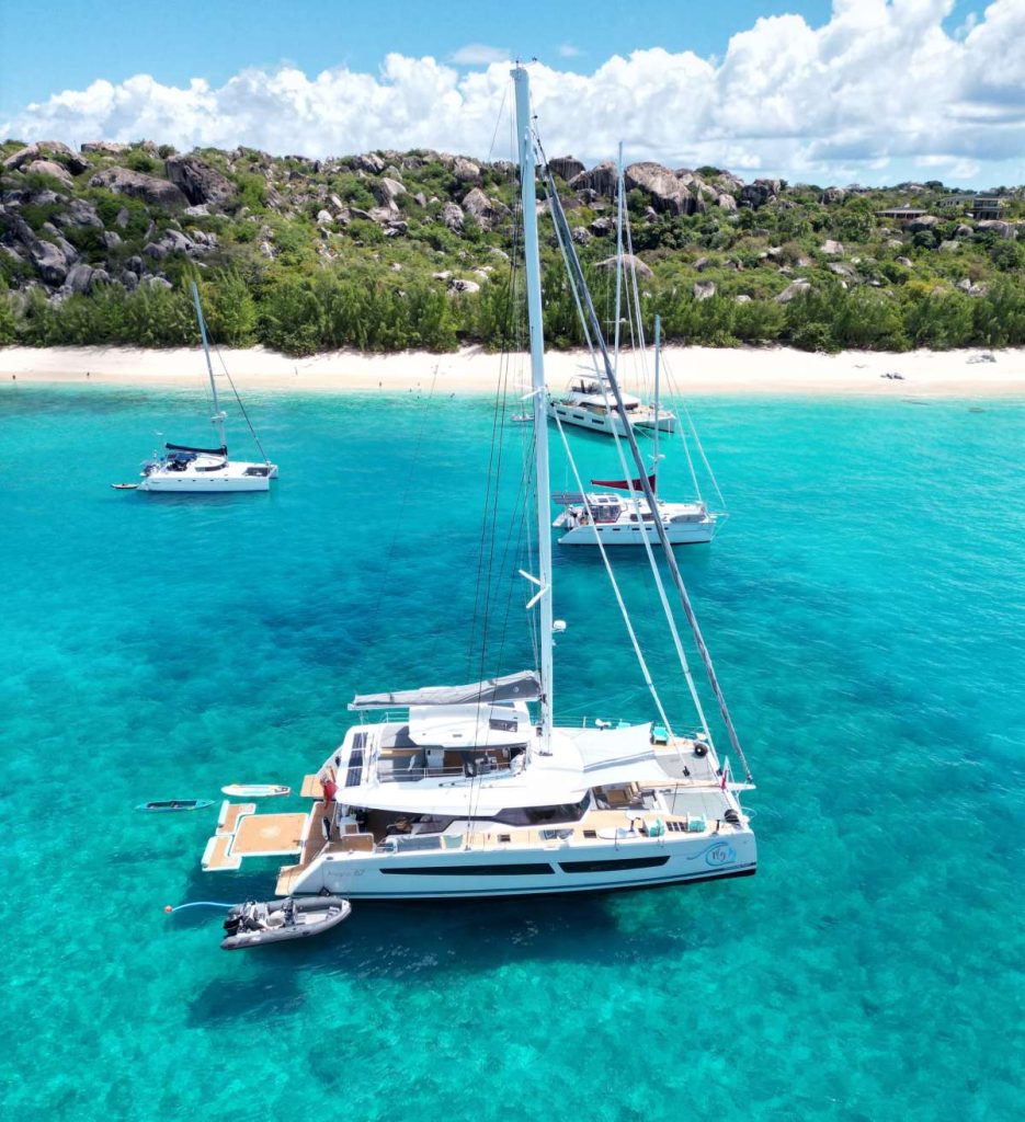 Charter catamaran yachts at anchor in crystal blue waters in the British Virgin Islands.