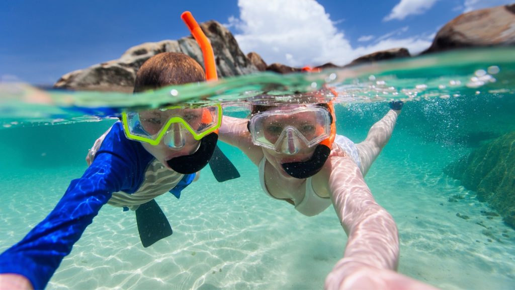 Split photo of mother and son family snorkeling in turquoise ocean water in the Grenadines.