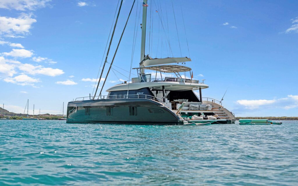 Luxury charter catamaran at anchor in clear blue water in the British Virgin Islands
