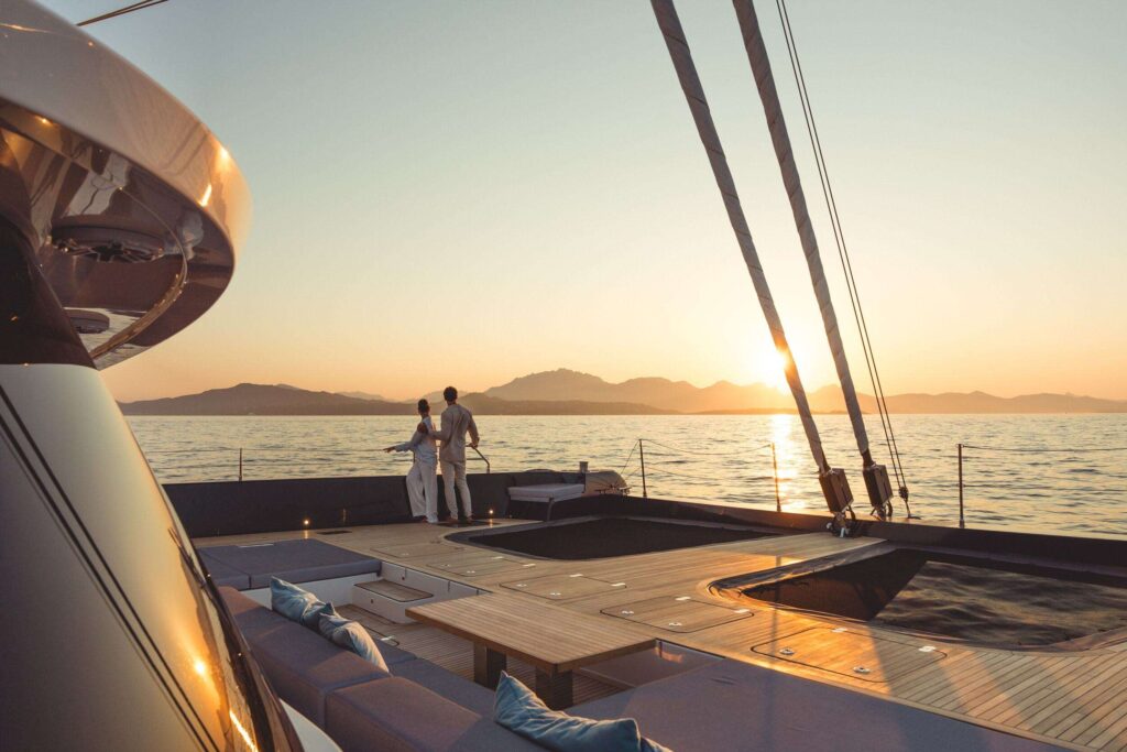 Guests watching the sunset from the deck of a charter yacht in the BVI